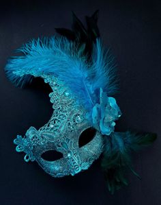 The brocade lace design with feathers adds a touch of sophistication and the jewels are carefully placed to catch the light and enhance your beauty. Securely and comfortably fits every face shape so you can enjoy a perfect evening at the masquerade ball.

Age Group/Gender - Adult/Women

Size/Type - One size fits all adults

Mask Color - Turquoise

Mask Material - Polyresin/Fabric

Accent Material - Gems Mardi Gras Mask Decorating Ideas, Elegant Feathered Masquerade Mask, Elegant Feathered Eye Mask For Masquerade, Elegant Blue Masquerade Mask For Parties, Elegant Feathered Masquerade Mask For Costume Party, Masquerade Mask Feathers, Blue Masquerade Mask, Masquerade Aesthetic, Fancy Mask