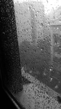 black and white photo of rain drops on window