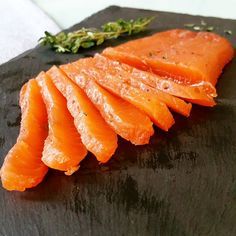 sliced up carrots sitting on top of a black cutting board