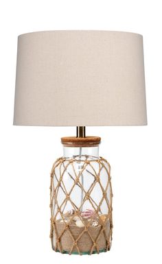 a glass lamp with a wooden base and rope wrapped around the bottom, on a white background