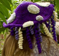 This handmade Lavender Dreams Wisteria Mushroom hat is decorated with wisteria-like curly-q's for flower loving mushroom fae everywhere. Purple Mushroom Costume, Whimsical Adjustable Purple Costume Hats And Headpieces, Whimsical Handmade Crochet Hat, Whimsical Crochet Yarn Bucket Hat, Mushroom Witch Hat Crochet, Whimsical Yarn Bucket Hat, Purple Whimsical Costume Hat, Purple Mushroom Hat, Mushroom Fae