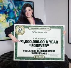 a woman is holding up a large check for $ 1, 000 00 a year