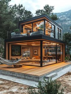 a house that is sitting on top of a wooden deck with hammock hanging from it's roof