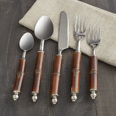 four silverware sets with wood handles and spoons