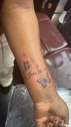 a woman's foot with a butterfly tattoo on her left arm and the words, you