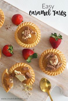 some desserts are sitting on a cutting board with strawberries