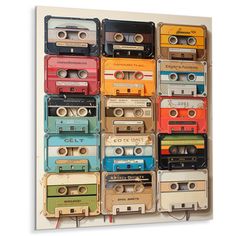 an old school cassette player wall hanging on a wall with tape recorders attached to it