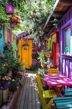 brightly colored wooden benches and tables in front of colorful houses with flowers on the porch