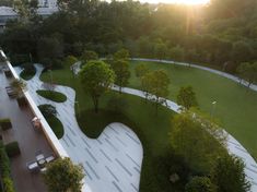 an aerial view of a park with benches and trees