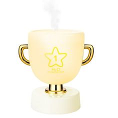 a white cup with a gold handle and a star on the top that is lit up