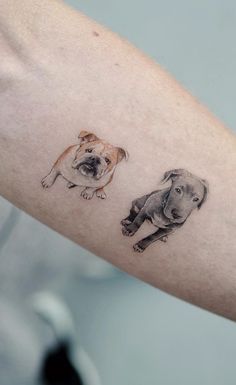 a person with a tattoo on their arm that has two pictures of dogs on it