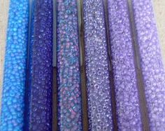 purple and blue beads are lined up together