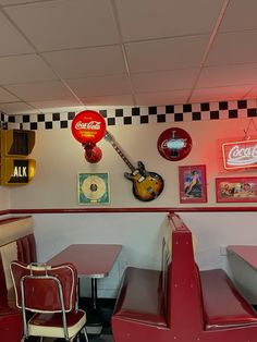 the interior of a diner with red booths and checkered walls