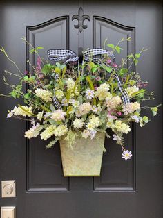 a potted planter filled with flowers on the front door