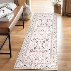 a large rug on the floor in a room with wooden floors and a bench next to it