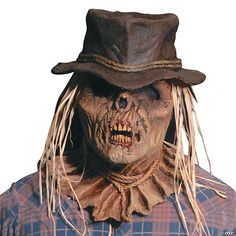 a man wearing a scarecrow mask and hat