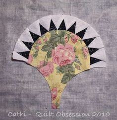 a hand made fan with flowers on it