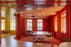 a conference room with red curtains and chairs