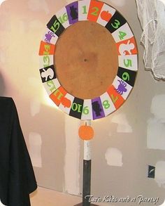 a man standing in front of a halloween themed clock