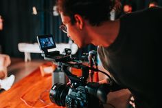 a man with a camera on a wooden table