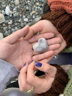 two people holding rocks in their hands