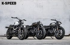 three motorcycles parked next to each other in front of a wall with the words k - speed written on it