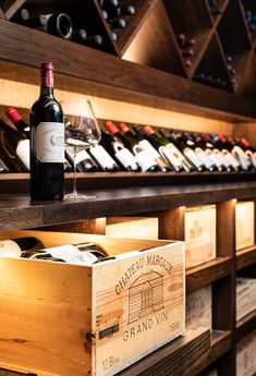 wine bottles and glasses are on display in the cellars at chateau marbreuxe grand vi