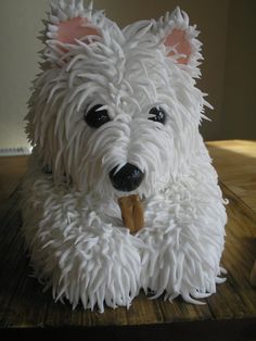 there is a cake made to look like a white dog