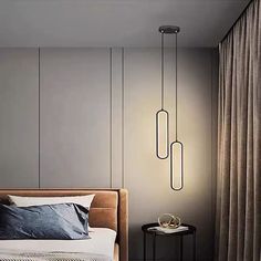 a bedroom with two lamps hanging from the ceiling and a bed in front of it