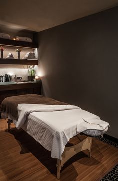 a treatment room with two massage tables and lights