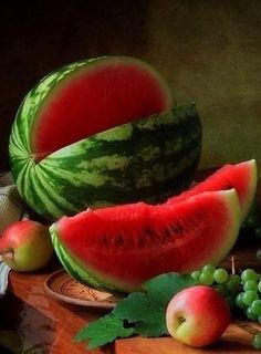 watermelon, apples and grapes on a cutting board