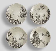 four black and white plates with trees on them