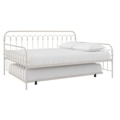 a white metal daybed with two pillows on it's sides and one bed frame