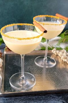 two martinis with cinnamon garnish sit on a tray