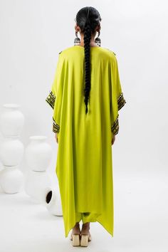 Green long kaftan kurta with hand embroidered ajrakh patch yoke in front. Comes with pant.
Components: 2
Pattern: Embroidered
Type Of Work: Ajrakh, Sequin, Zari, Thread
Neckline: Notched
Sleeve Type: Batwing
Fabric: Satin
Color: Green
Other Details: 
Note: Potli bag held by the model is not for sale
Occasion: Mehendi and Haldi - Aza Fashions Kaftan Kurta, Potli Bag, Long Kaftan, Potli Bags, Satin Color, Green Satin, Pant Set, Bat Wings, Set For Women