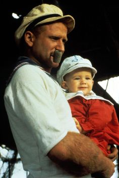 a man holding a small child in his arms