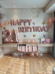 a 21st birthday party with balloons, streamers and decorations on the wall behind it