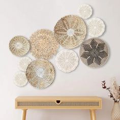 a table with some baskets on it next to a vase and flower in a vase