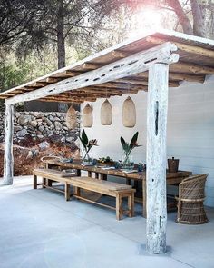 an open magazine with a table and bench in front of some stone wall hanging from the ceiling