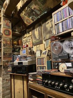 a room filled with lots of different types of audio equipment and books on the shelves