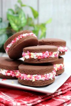 chocolate covered cookies with sprinkles on a plate