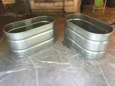 two metal tubs sitting on top of plastic