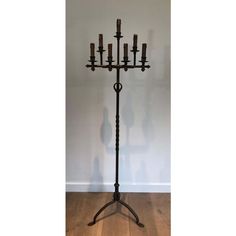 an iron candelabra with eight candles on it