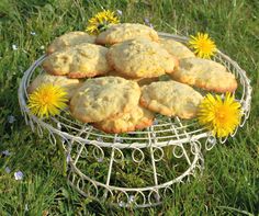 some cookies are on a wire rack with dandelions