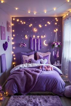 a purple bedroom with lights strung from the ceiling and decorations on the wall above the bed