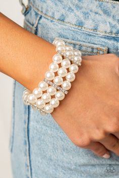 Held together by white rhinestone dotted silver fittings, row after row of bubbly white pearls are threaded along stretchy bands around the wrist for a timeless elegance.

 Sold as one individual bracelet. White Pearl Bracelet, White Bracelet, Beads Bracelet Design, White Bracelets, Jewelry Model, Wedding Styling, Paparazzi Accessories, Bracelet Design, Stretchy Bracelets