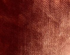 the back side of a red cloth with small holes in it's middle section