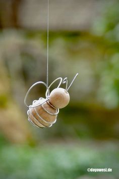 a wooden object hanging from a string