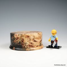 a wooden box with a lego figure next to it