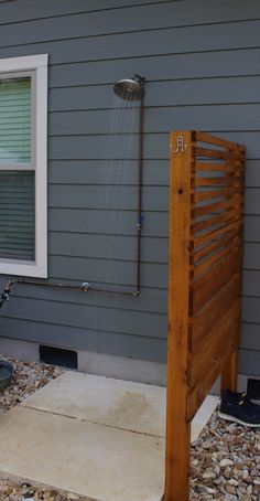 an outside shower with water coming from the faucet